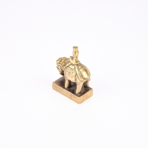 175 - A CHINESE BRONZE SEAL modelled in the form of a caparisoned elephant standing four square. 5.6cm hig... 