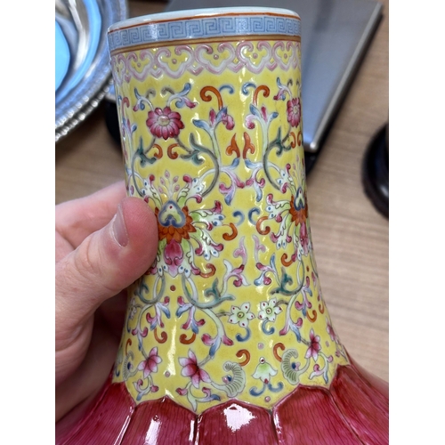 176 - A CHINESE FAMILLE ROSE 'LOTUS' BOTTLE VASE the lower body brightly enamelled with a double row of up... 