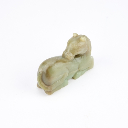 182 - A 19TH CENTURY CHINESE JADE CARVING OF A RECUMBENT HORSE carved with the horse depicted lying with l... 