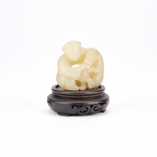 215 - A 19TH CENTURY CHINESE JADE 'BOY AND DOG' GROUP finely carved as a playful boy and dog, the stone of... 