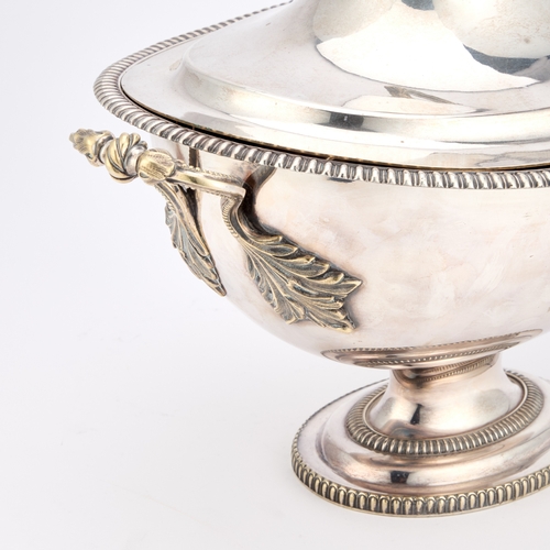 246 - A 19TH CENTURY SILVER-PLATED SOUP TUREEN oval with rounded sides and twin handles, the domed cover w... 