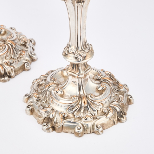 256 - A PAIR OF 19TH CENTURY SILVER-PLATED CANDLESTICKS boldly cast with scrolls and foliage. (2) 23cm hig... 