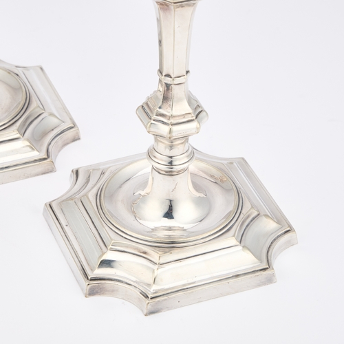 259 - A PAIR OF GEORGE II STYLE SILVER-PLATED CANDLESTICKS by Elkington & Co, with a square-section kn... 