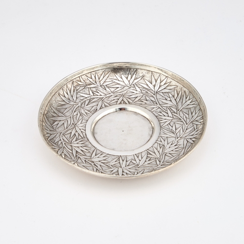 294 - A CHINESE SILVER CUP AND SAUCER mark of Wang Hing, c.1900, the double-skinned cup decorated in relie... 