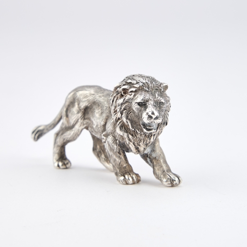 349 - AN ELIZABETH II CAST SILVER MODEL OF A LION by Mappin & Webb Ltd, London 1987, modelled standing... 