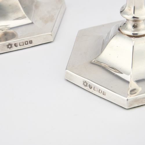 352 - A PAIR OF ELIZABETH II SILVER CANDLESTICKS by D J Silver Repairs, London 1963, with a hexagonal scon... 