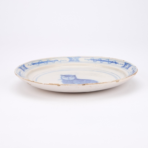 42 - A 18TH/ 19TH CENTURY BLUE AND WHITE FAIENCE 'CAT' PLATE of circular form, underglaze blue painted wi... 