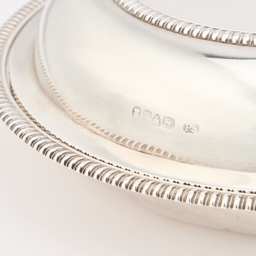 451 - A GEORGE IV SILVER ENTRÉE DISH AND COVER by Paul Storr, London 1825, circular, with reel moulded bor... 