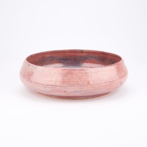 53 - AN INTERESTING STUDIO POTTERY BOWL of circular form with rounded sides, the exterior covered in a va... 