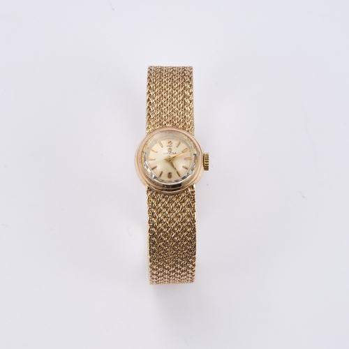 549 - A LADY'S 9CT GOLD OMEGA BRACELET WATCH the circular silvered dial signed Omega, with gilt baton indi... 