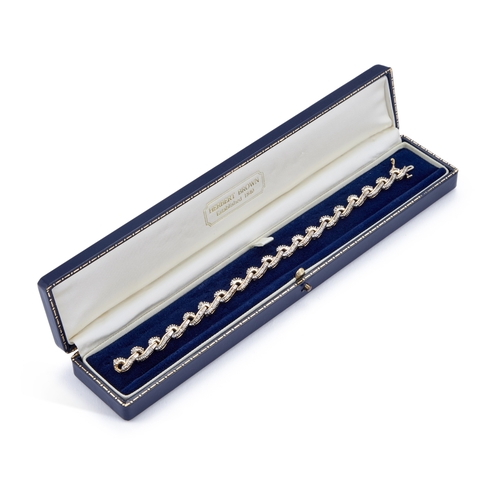 616 - A DIAMOND BRACELET articulated scroll links set throughout with baguette-cut diamonds, unmarked. Est... 