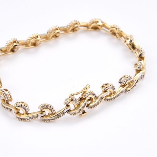 616 - A DIAMOND BRACELET articulated scroll links set throughout with baguette-cut diamonds, unmarked. Est... 