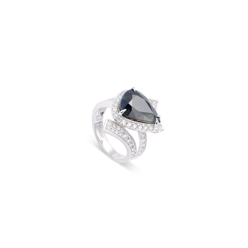 652 - A SAPPHIRE AND DIAMOND CLUSTER RING a pear-cut sapphire within a border of round brilliant-cut diamo... 