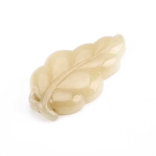 79 - A CHINESE JADE BRUSH WASHER carved in the form of a leaf, the stone of pale celadon tone with natura... 