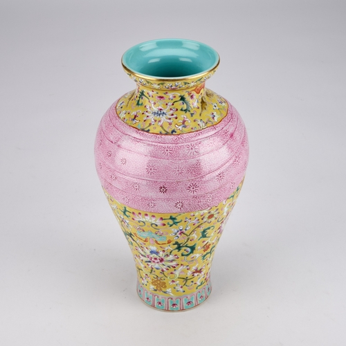 94 - A CHINESE FAMILLE ROSE YELLOW-GROUND VASE of baluster form, moulded with a tied pink swag, bears an ... 