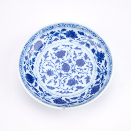 95 - A CHINESE BLUE AND WHITE PORCELAIN DISH IN MING STYLE, LATE QING DYNASTY circular with rounded sides... 