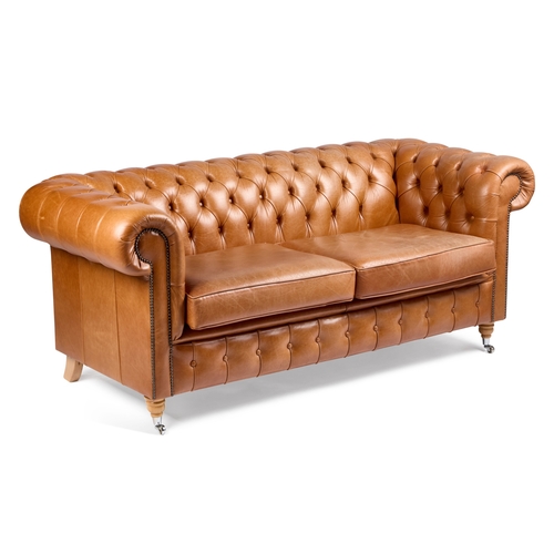 955 - A TAN LEATHER UPHOLSTERED CHESTERFIELD SOFA with a buttoned back, arms and front, raised on turned w... 