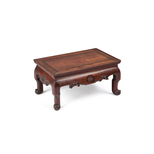 959 - A CHINESE HARDWOOD KANG TABLE CIRCA 1900 of typical rectangular form, the frieze carved with flowerh... 