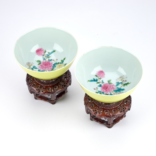 97 - A PAIR OF CHINESE FAMILLE ROSE PORCELAIN BOWLS WITH YELLOW GROUND circular with rounded sides, ename... 