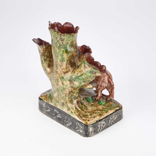 106 - A STAFFORDSHIRE POTTERY 'LION' SPILL VASE CIRCA 1830 modelled with the figure of a lion with a paw r... 