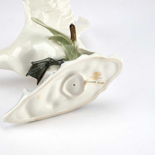 112 - A HUTSCHENREUTHER PORCELAIN MODEL OF A SWAN modelled with outstretched wings as it gracefully comes ... 