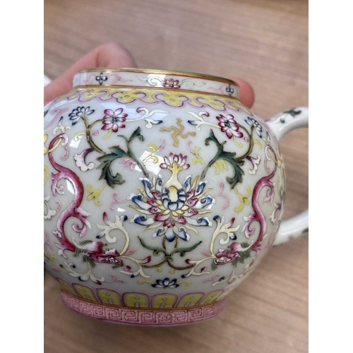 147 - A CHINESE FAMILLE ROSE TEAPOT enamel painted with lotus flowers and scrolling tendrils, bears an und... 