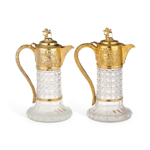 497 - A PAIR OF VICTORIAN SILVER-GILT MOUNTED CUT-GLASS CLARET JUGS by Charles Boyton (II), London 1883 an... 