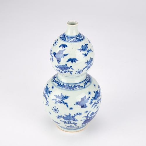 158 - A CHINESE BLUE AND WHITE GOURD VASE 23cm high