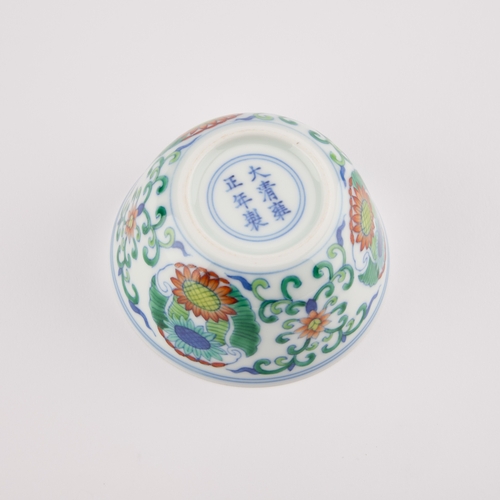 202 - A CHINESE DOUCAI CUP decorated with three floral medallions, bears an underglaze blue six-character ... 