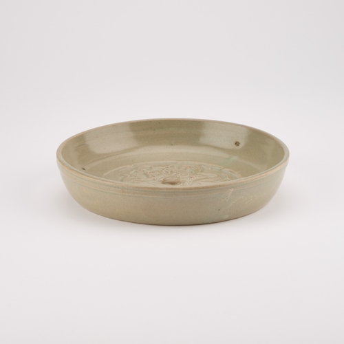 204 - A CHINESE CELADON BRUSH WASHER circular, moulded in relief with a Kylin. 17.5cm diameter