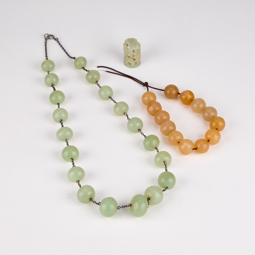 232 - A NEPHRITE BEAD NECKLACE, A NEPHRITE BEAD BRACELET AND A CHINESE NEPHRITE CARVING (3)