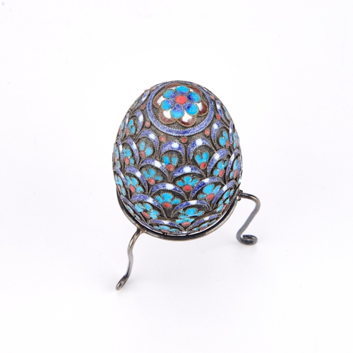 305 - A CONTINENTAL SILVER AND ENAMEL EGG ON STAND the egg and stand stamped 950. (2)