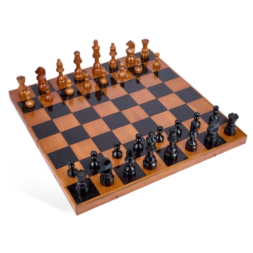 428 - A VINTAGE FOLDING GAMES BOARD AND CHESS PIECES Board 72.5cm square