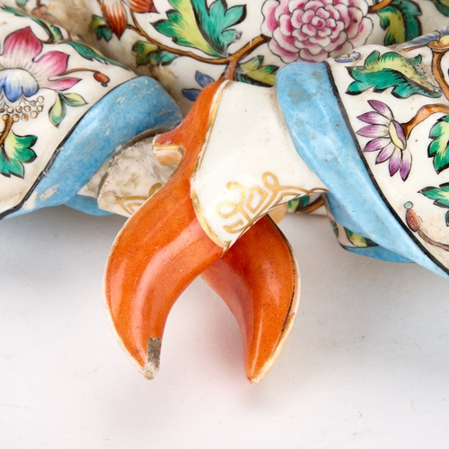 87 - A 19TH CENTURY CONTINENTAL PORCELAIN PAGODA FIGURE BASE IN MEISSEN STYLE modelled seated cross-legge... 