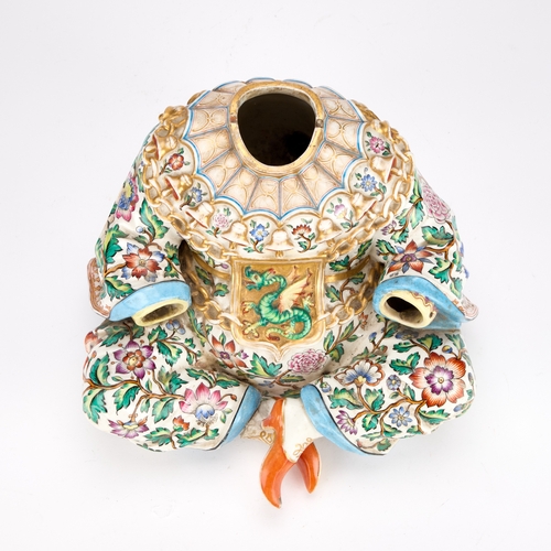 87 - A 19TH CENTURY CONTINENTAL PORCELAIN PAGODA FIGURE BASE IN MEISSEN STYLE modelled seated cross-legge... 