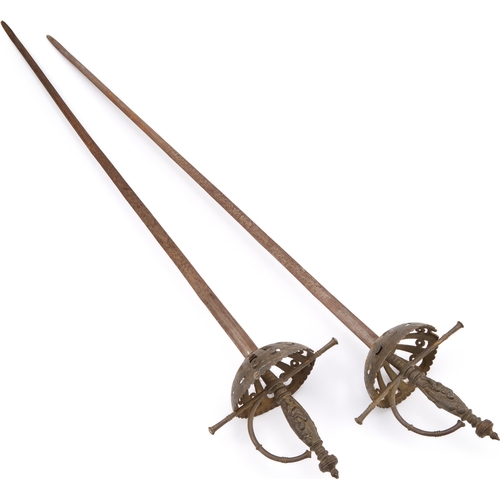 17 - TWO CUP-HILT RAPIERS each with pierced iron guard and engraved blade. (2) 102cm long overall