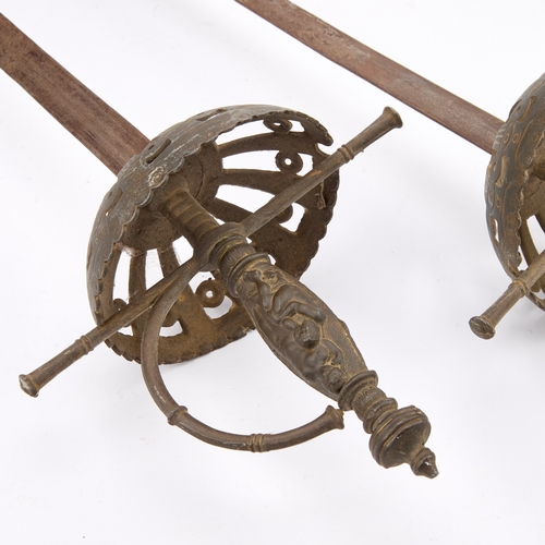 17 - TWO CUP-HILT RAPIERS each with pierced iron guard and engraved blade. (2) 102cm long overall