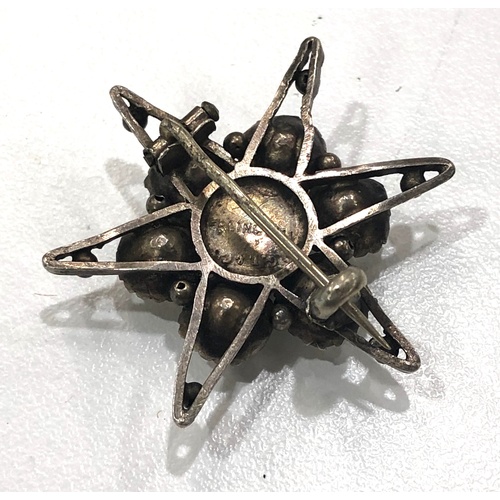 515A - Antique sterling silver paste set starburst brooch