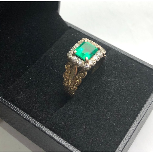 113 - 18ct gold diamond and emerald ring set with large central emerald that measures approx 7mm by 6.5mm ... 