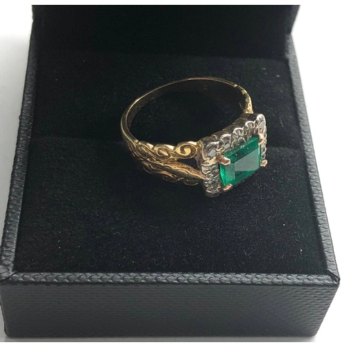 113 - 18ct gold diamond and emerald ring set with large central emerald that measures approx 7mm by 6.5mm ... 