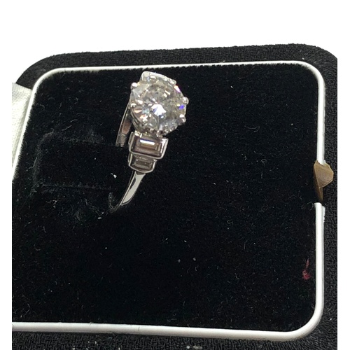 169 - Fine 1.25ct diamond ring central diamond measures approx 7.5mm dia with baguette diamods either side... 