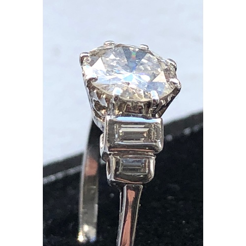 169 - Fine 1.25ct diamond ring central diamond measures approx 7.5mm dia with baguette diamods either side... 