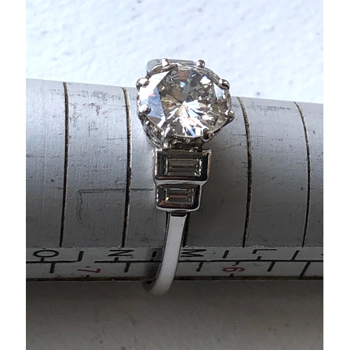 169 - Fine 1.25ct diamond ring central diamond measures approx 7.5mm dia with baguette diamods either side... 