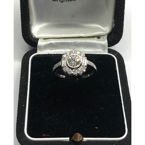 174 - Platinum and diamond cluster ring central diamond measures approx 5.5mm dia set with diamonds around