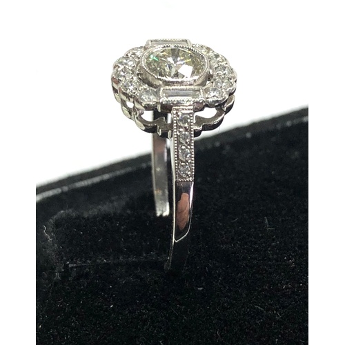 174 - Platinum and diamond cluster ring central diamond measures approx 5.5mm dia set with diamonds around