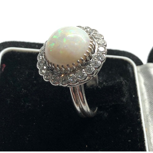 184 - 18ct white gold diamond and opal ring the central opal measures approx 14mm dia with diamonds around... 