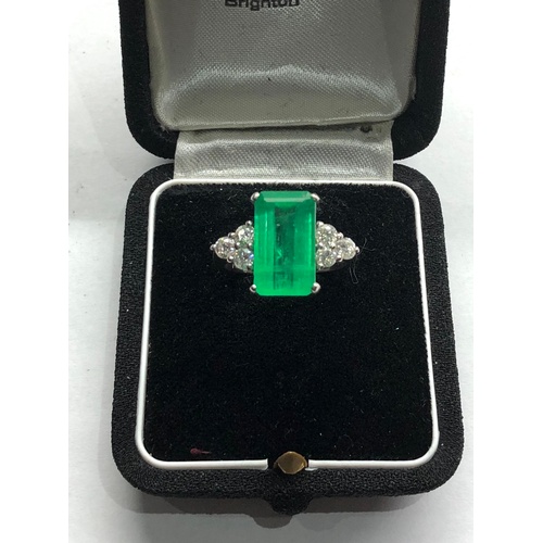 186 - Platinum Emerald and diamond ring large central emerald measures approx 15mm by 8.5mm set with  diam... 