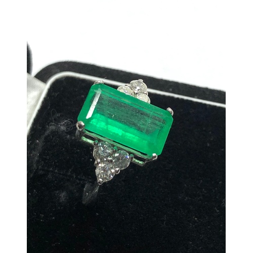 186 - Platinum Emerald and diamond ring large central emerald measures approx 15mm by 8.5mm set with  diam... 