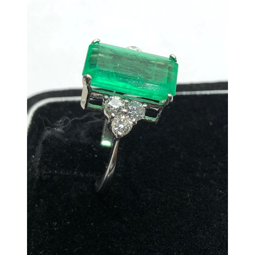 186 - Platinum Emerald and diamond ring large central emerald measures approx 15mm by 8.5mm set with  diam... 