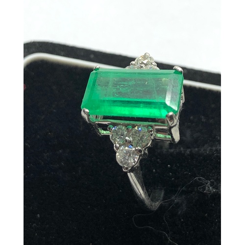 186 - Platinum Emerald and diamond ring large central emerald measures approx 15mm by 8.5mm set with  diam... 